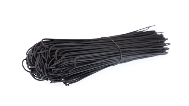 Bunch of black spaghetti isolated on white background.