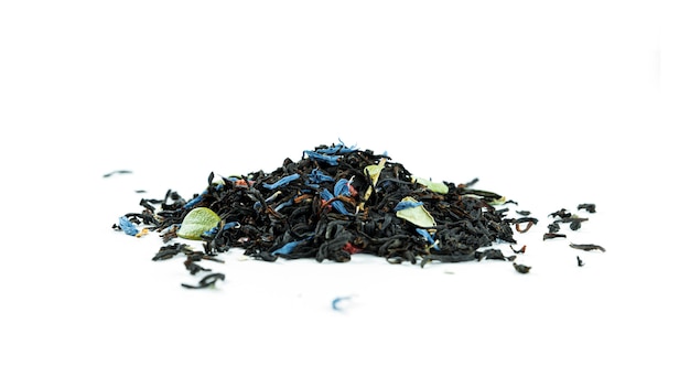 Bunch of black tea leaves with fruits isolated.