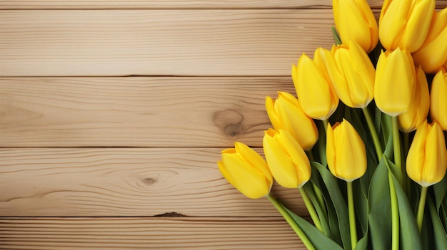 Bunch of blooming yellow tulips on wooden background