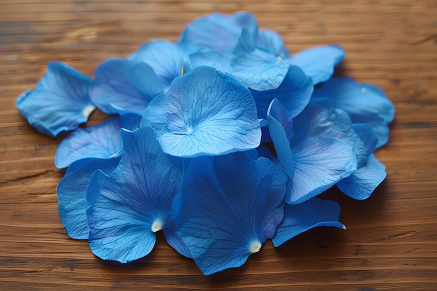 Photo a bunch of blue flowers on a wooden table top with a wooden surface in the background and a wooden