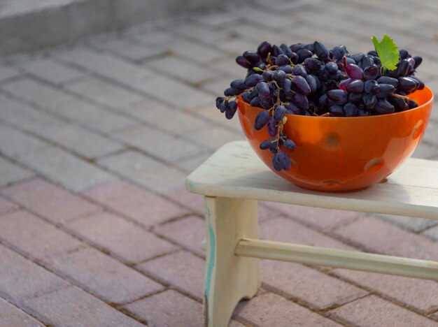 Bunch of bluered Moldovan grapes and autumn yellow foliage in Greece