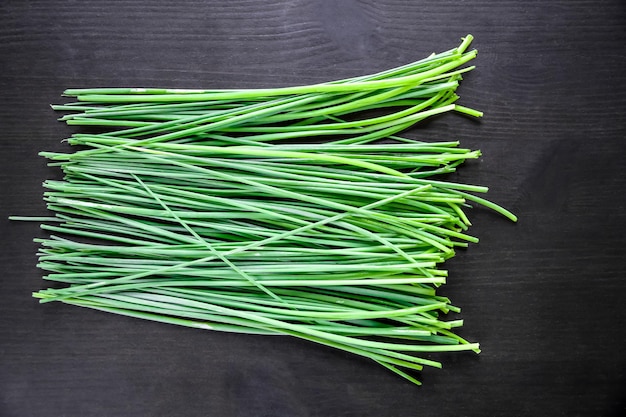 Photo bunch of chives isolated on black