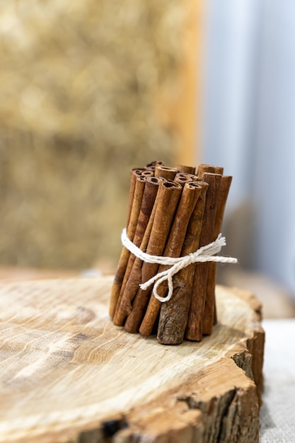 Bunch of cinnamon sticks on a wooden stump. Natural food condiment.