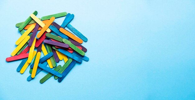 a bunch of colored sticks on a blue background free space. Mix of flowers