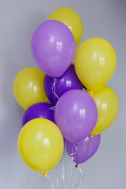 A bunch of colorful balloons with helium