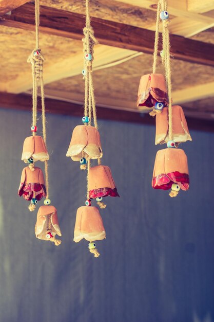 A bunch of colorful miniature bells hanging on display