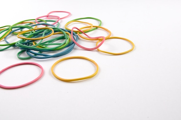 Premium Photo  Bunch of colorful multi color small rubber bands elastic  bands on a white background close up