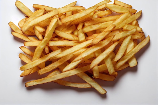 Bunch of crispy hot french fries isolated on white background