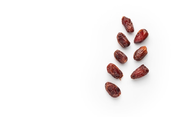 A bunch of dates are scattered on a white background