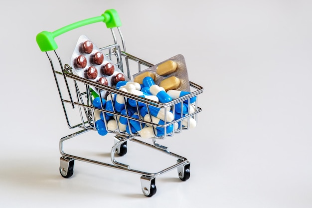 A bunch of different pills on a light background Piling up in the shopping cart