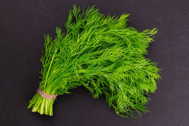 A bunch of dill on a black background Flat lei