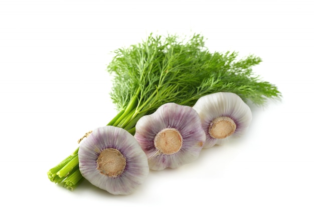 Bunch of dill and garlic on white surface