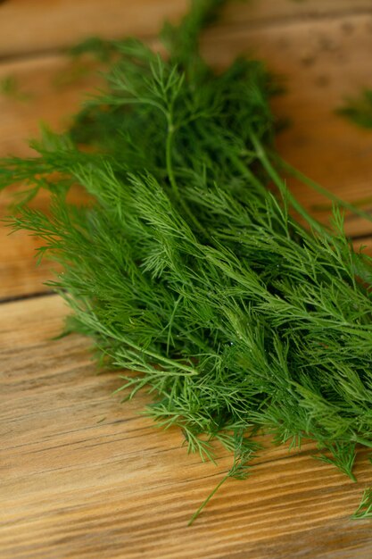 A bunch of dill on a wooden board