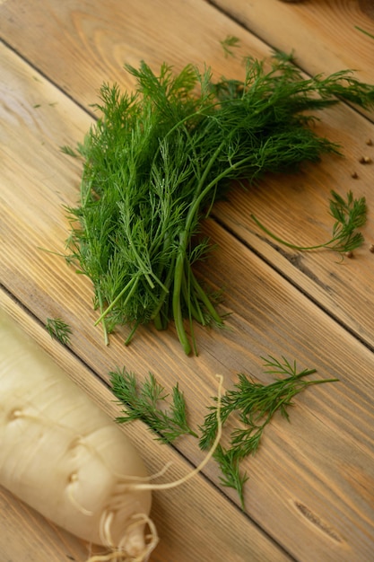 A bunch of dill on a wooden board