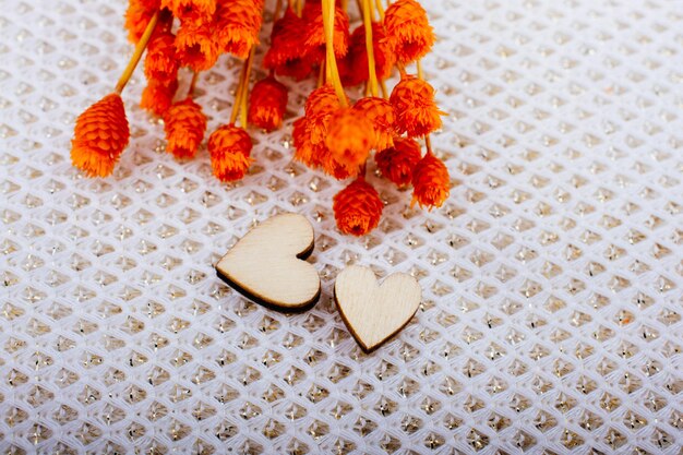 Bunch of dried flower and heart on white background