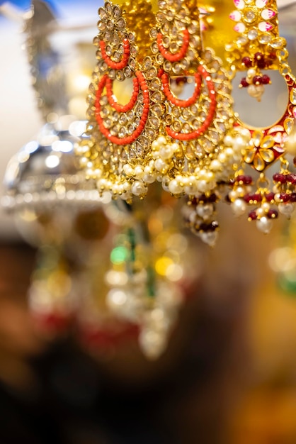 A bunch of earrings are hanging from a ceiling.