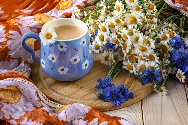 A bunch of flowers and a cup of coffee