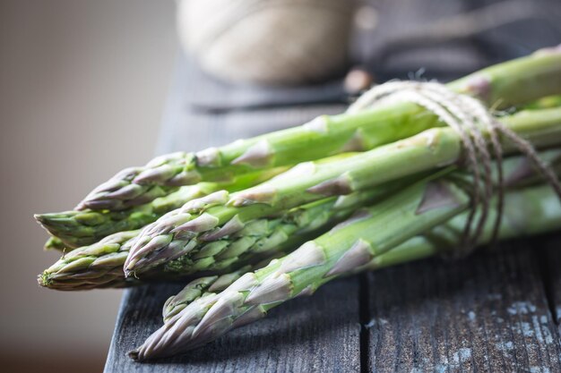 Bunch of fresh asparagus on wooden table