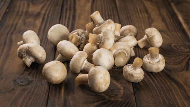 A bunch of fresh mushrooms on a rustic background