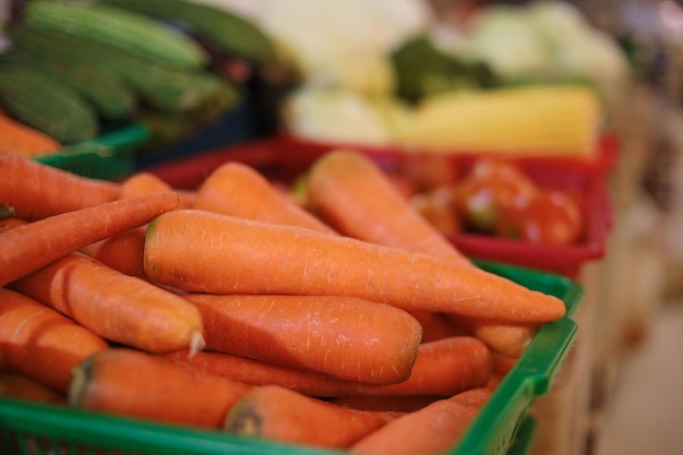 Bunch of fresh ripe orange carrots placed on stall in local market