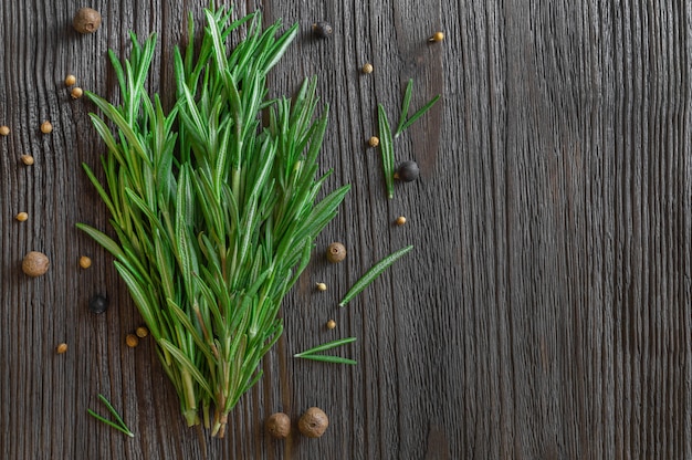 Bunch of fresh rosemary and spices background