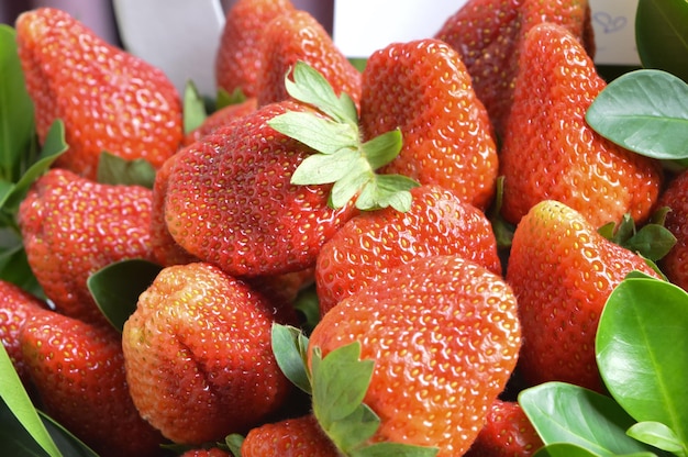 Bunch of fresh strawberries on shelf