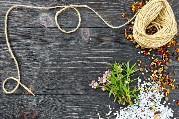 Bunch of fresh thyme with green leaves and pink flowers, salt, pepper, fenugreek seeds