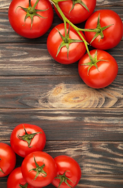 Bunch of fresh tomatoes on brown background Harvesting tomatoes Space for text