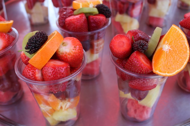 A bunch of fruit cups with one that says " fruit " on it