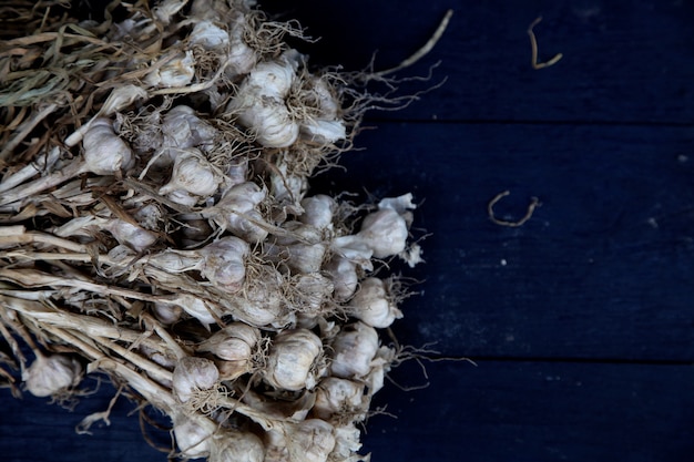 A bunch of garlics on the blue board