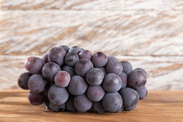 Bunch of grapes for red wine on the table