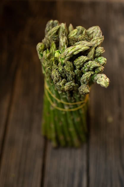 a bunch of green asparagus on a dark background