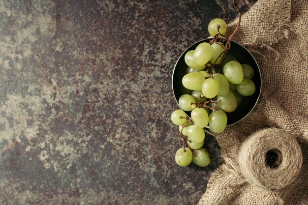 Bunch of green grapes on a dark background.