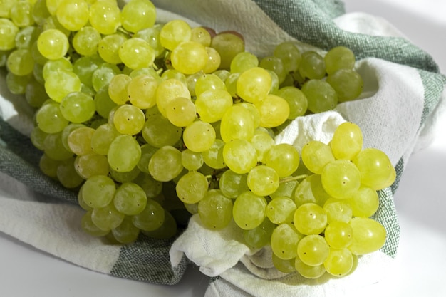 Bunch of green grapes on white background