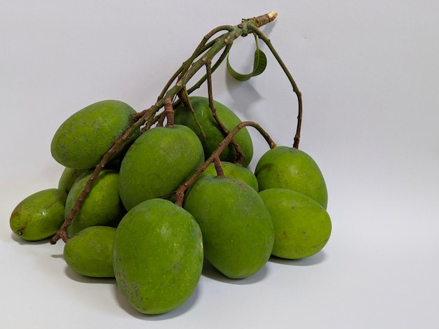 A bunch of green mangoes on isolated background