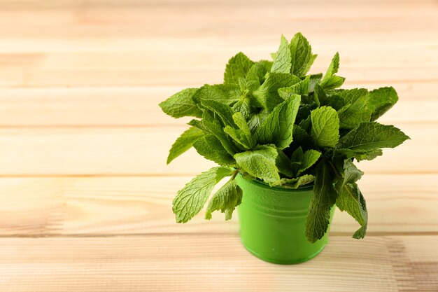 Bunch of green mint on wooden space