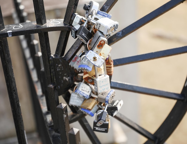 A bunch of keys on a metal fence with the word love on it