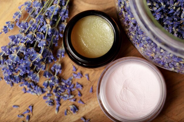 Bunch of lavender and cosmetic pot on a wooden table