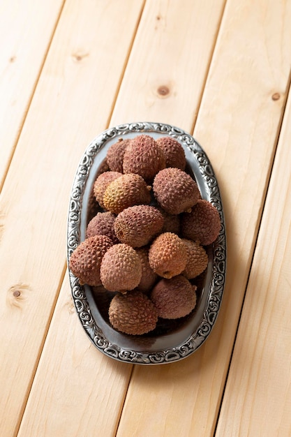 Bunch of lychee fruit in a metal plate