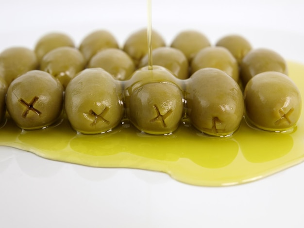 a bunch of olives being poured into a container