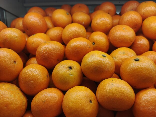 a bunch of oranges that are in a bin