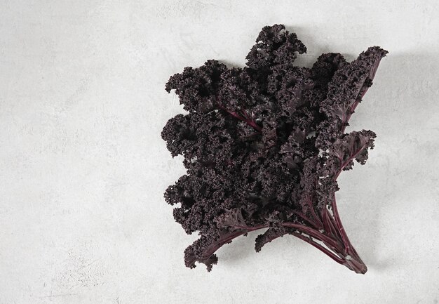 Bunch of organic kale on a on light background top view copy space