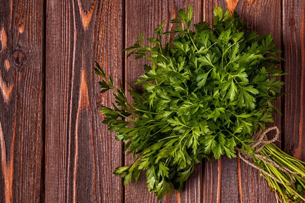 Bunch of parsley on a wooden table.