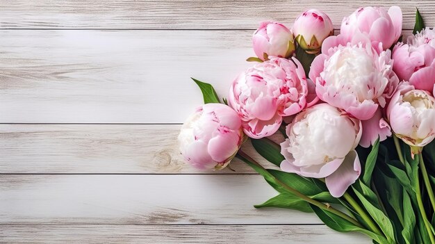 A bunch of peonies on a white wooden background