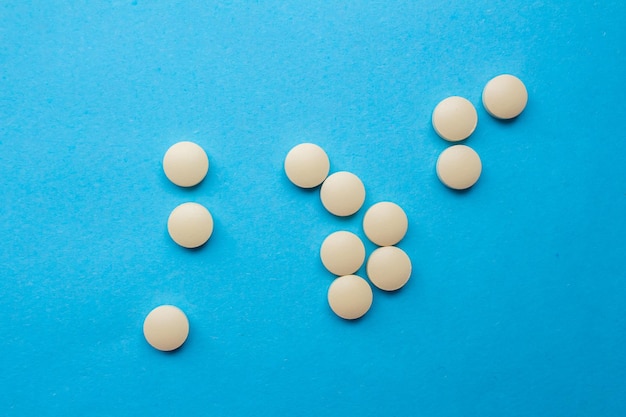 A bunch of pills with the numbers 1 and 1 on a blue background