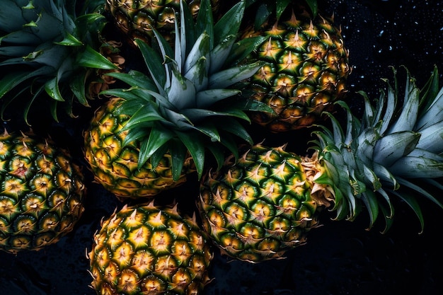 A bunch of pineapples with green leaves