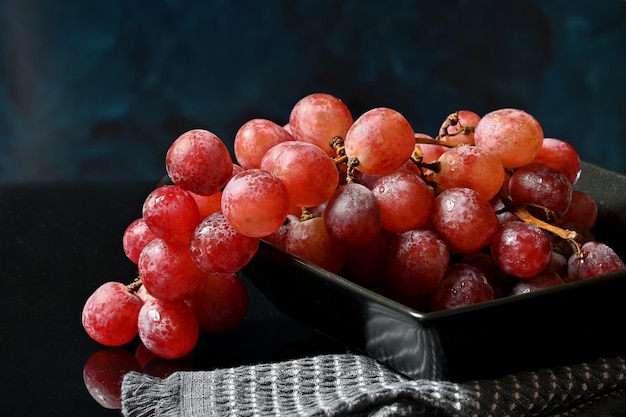 Bunch of pink grapes on a dark background