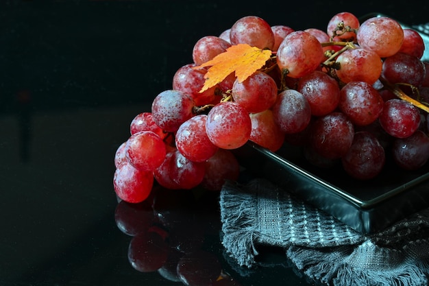 Bunch of pink grapes on a dark background