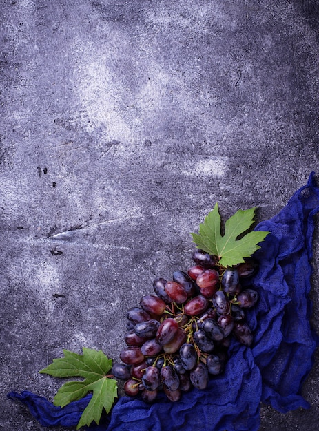 Bunch of purple grapes on concrete background