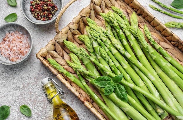 Bunch of raw asparagus stems with different spices